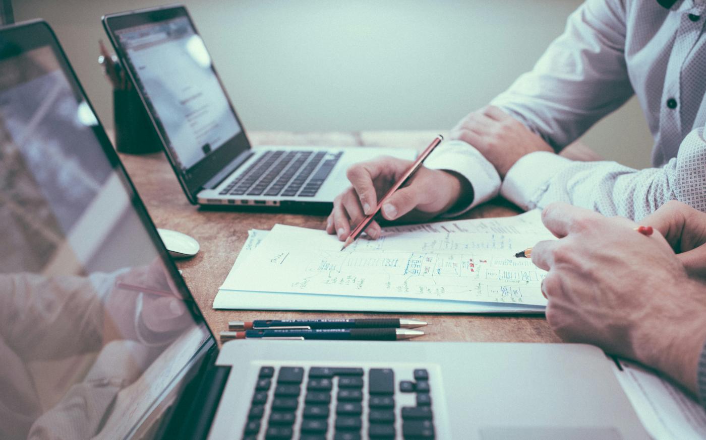 person holding pencil near laptop computer by Scott Graham courtesy of Unsplash.