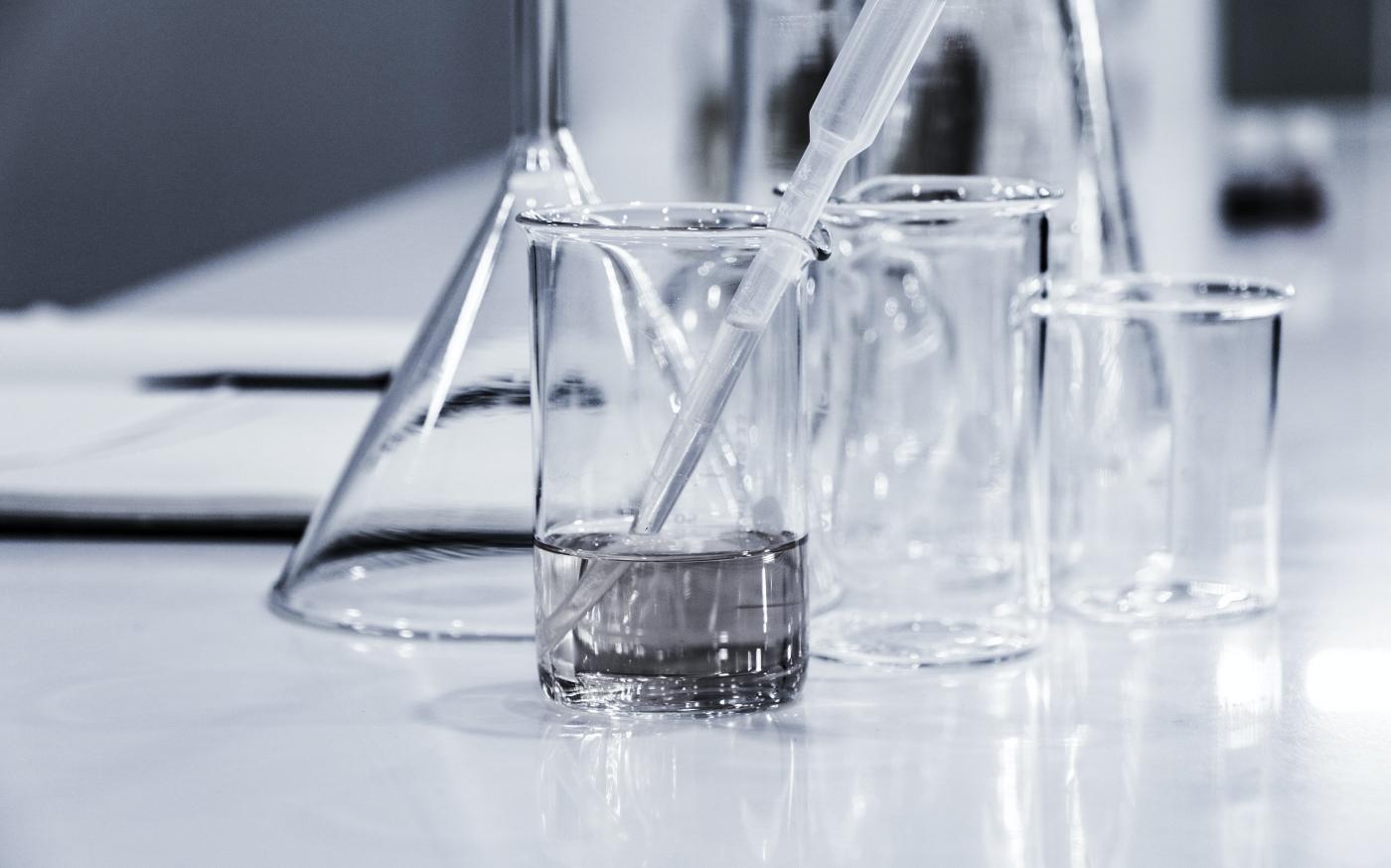 three clear beakers placed on tabletop by Hans Reniers courtesy of Unsplash.