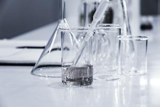 three clear beakers placed on tabletop by Hans Reniers courtesy of Unsplash.